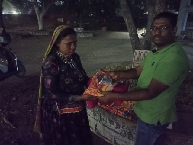 Volunteer delivering grocery to slum family